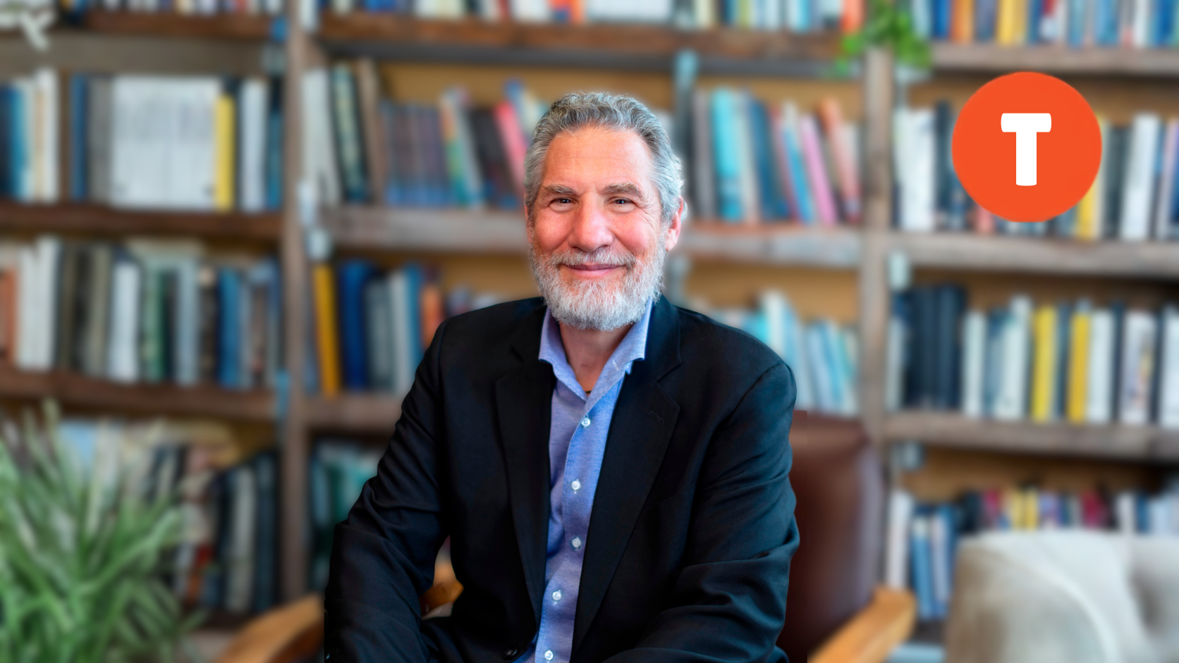 Jonathan F.P. Rose seated in front of bookshelves with the Tricycle logo